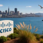 Cisco sign in front of San Francisco skyline, blue water, and clear sky.