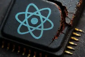Close-up of a damaged microchip featuring a blue atomic symbol.