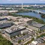 Aerial view of government buildings near the Potomac River and Washington Monument.