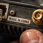 Close-up of electronic device showcasing a connection port and branding label.